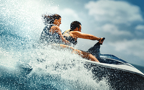 a woman, and a man riding a jet ski
