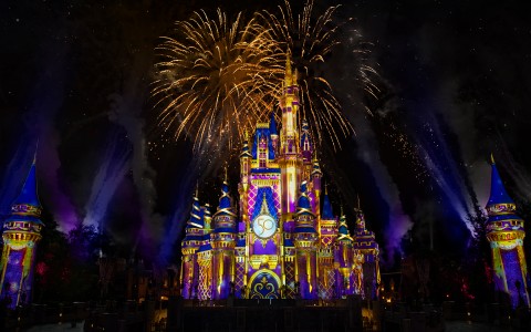 cinderella's castle with fireworks above it