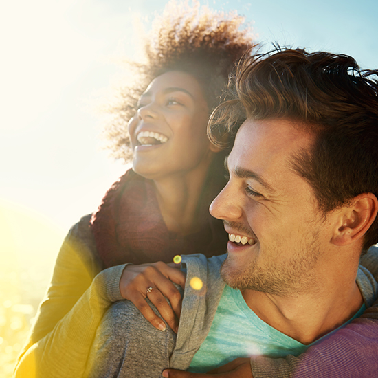 woman smiling on mans back