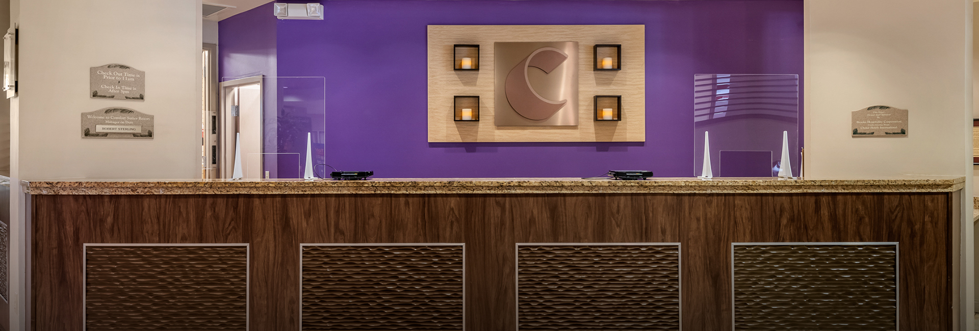 front desk with purple wallpaper