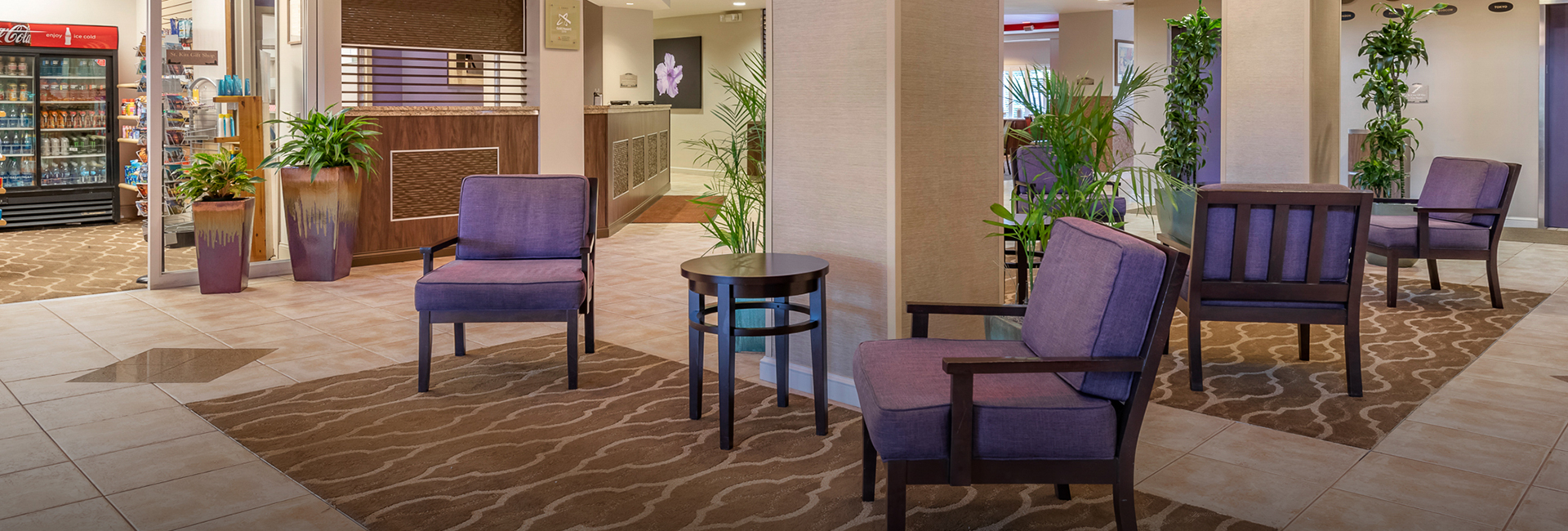 lobby of comfort suites with purple chairs