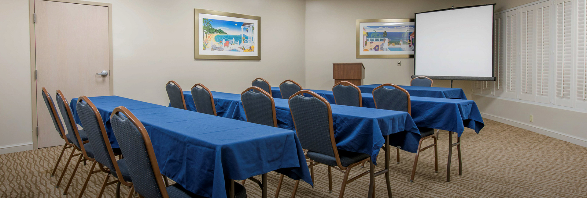 meeting room with blue tables and chairs in a line