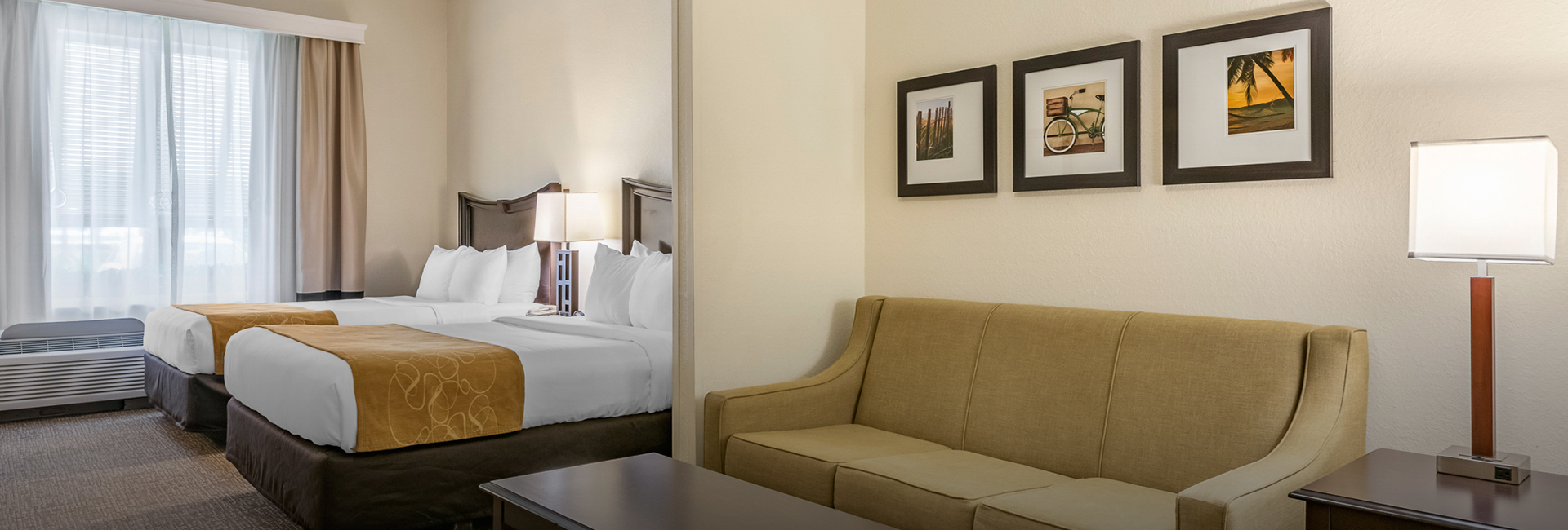 suite with double queen beds and sofa in room next door