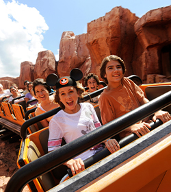group of people riding on rollercoaster surrounded by rocks