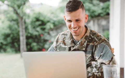 military man looking at a laptop