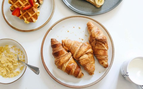 three croissants in a white plate
