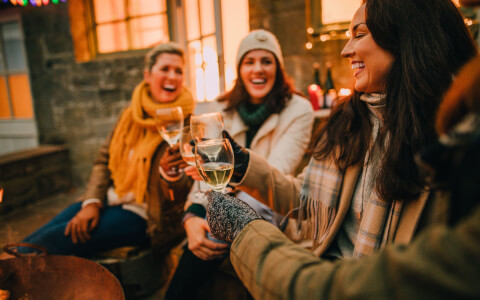 women toasting with wine of glasses