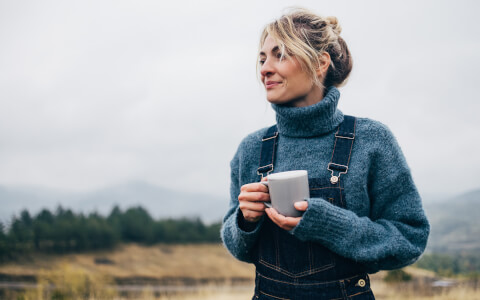 woman with a cup of coffee outside