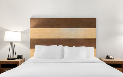 double bed with a wooden headboard 