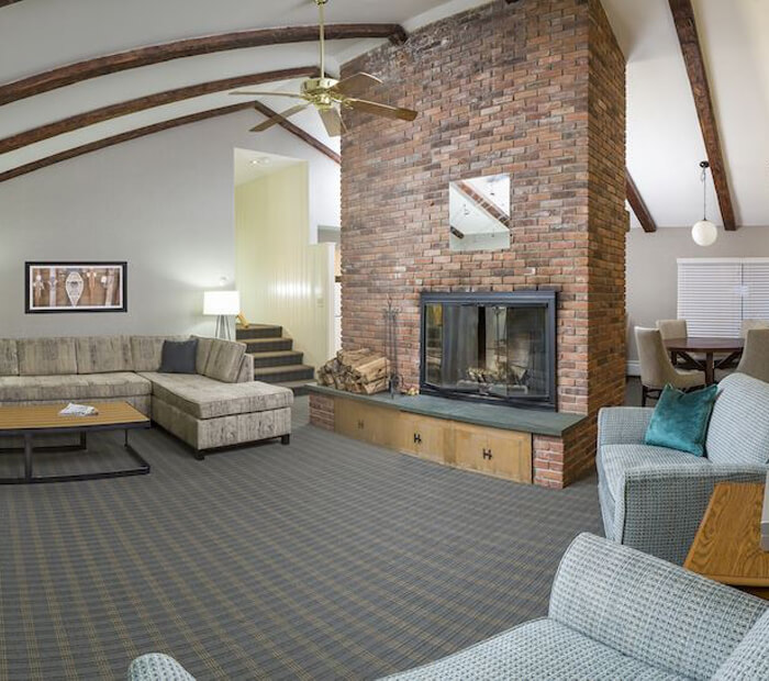 view of a living room with two sofas and a fireplace