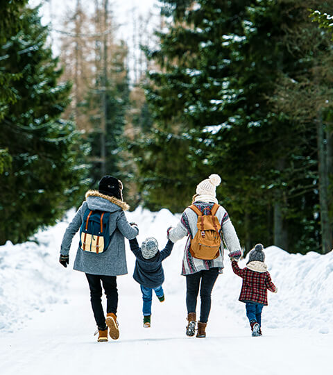 back view of a family with two children enjoying time in the snow
