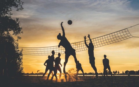 shadow of people playing beach volleyball