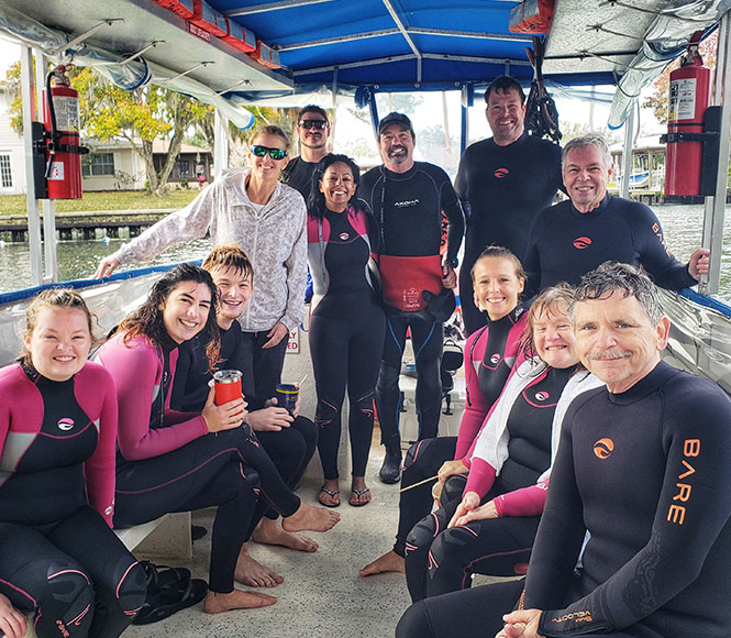 group of guys on a boat having a manatee and snorkeling experience 