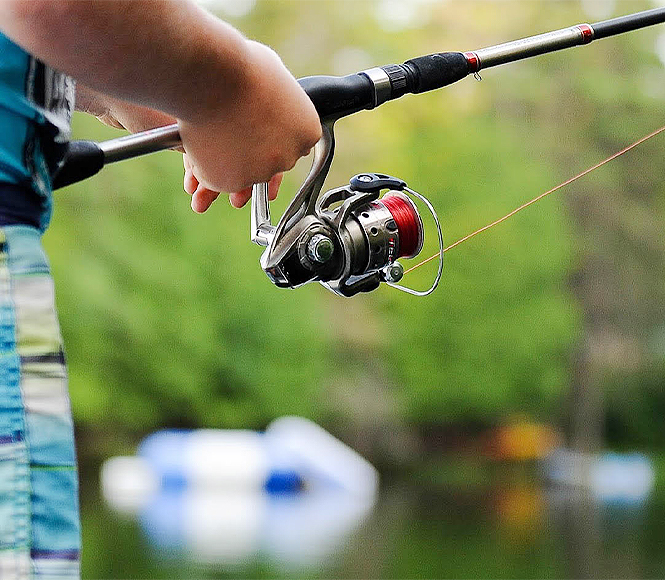 close up view of a hand holding a fishing rod