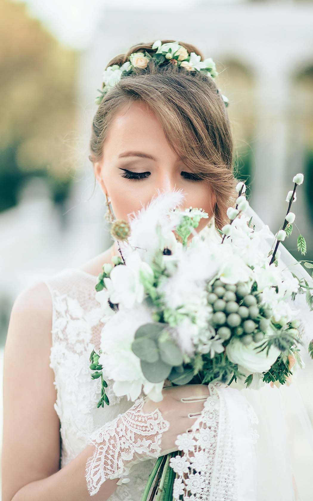 bride smelling and looking at her boutique of roses 