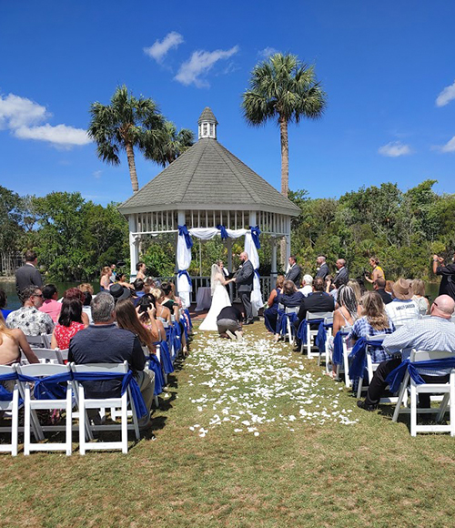 couple getting married in a landscape in blue and white accents