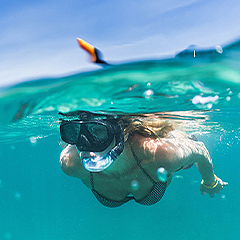 view under the water of a lady doing snorkeling 