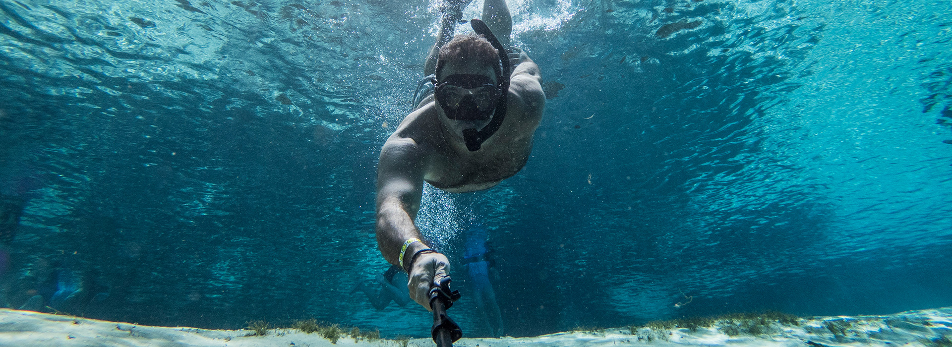view of a guy taking a selfie snorkeling 