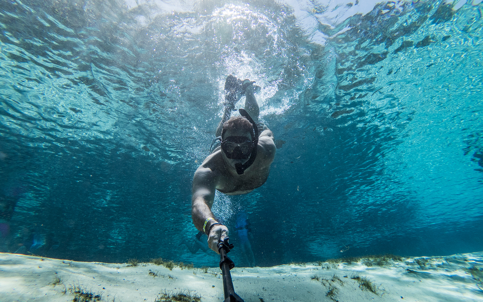 water view of a guy taking a selfie snorkeling