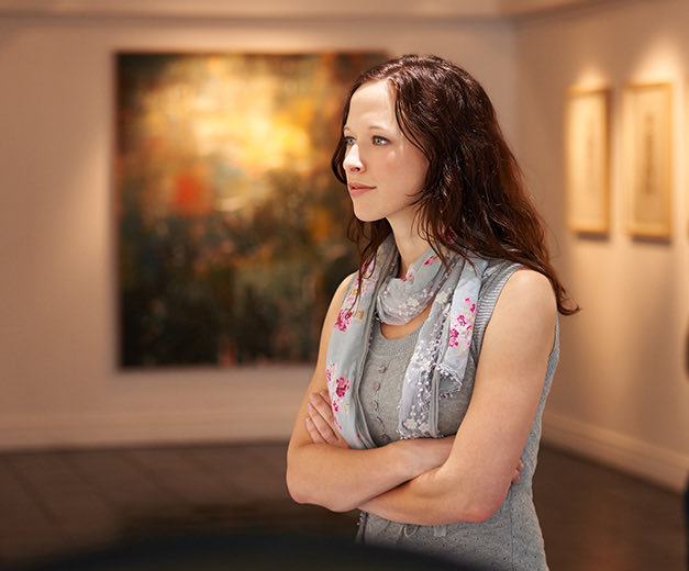 woman looking art at jepson center for the arts