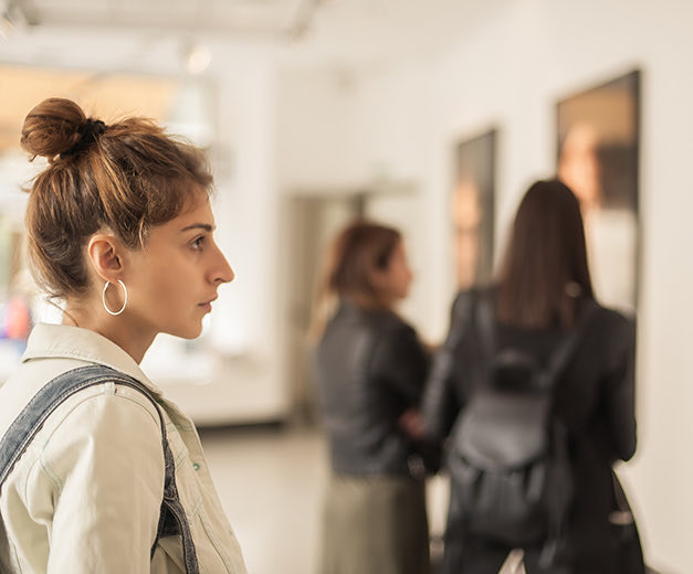 women looking art at a museum