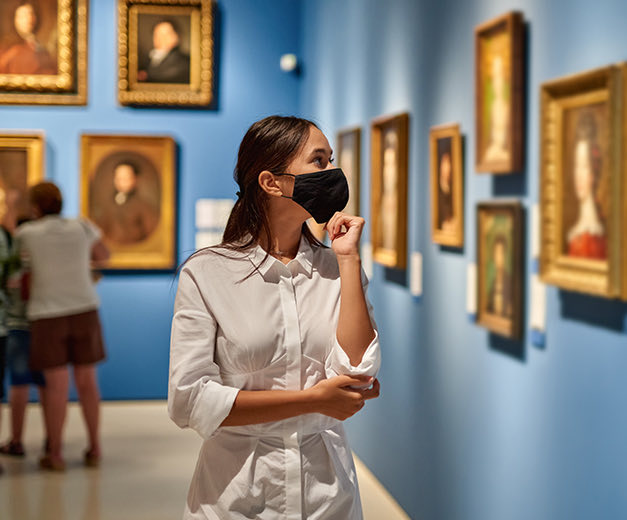 woman looking paintings in a museum