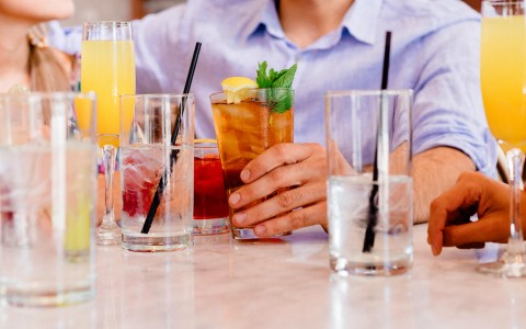 view of a man hand holding a cocktail