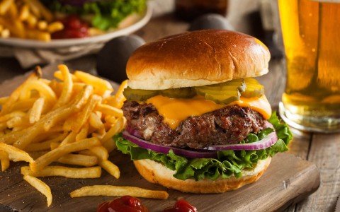 a delicious burger with cheese and fries 