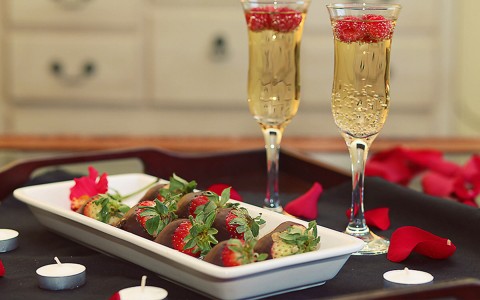 view of some strawberries with chocolate and two glasses of champagne 