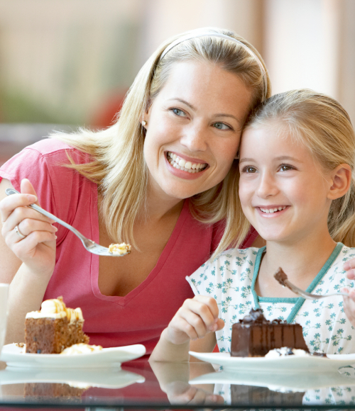 Mother and daughter eating cake