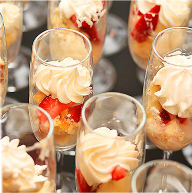 dessert with strawberries and whipped cream served in glasses